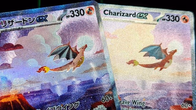 A close-up comparison of two Charizard ex Pokémon cards placed side by side, one Japanese and one English, highlighting differences in text, print texture, and holofoil finish while showing the same artwork of Charizard flying over a cloudy landscape.