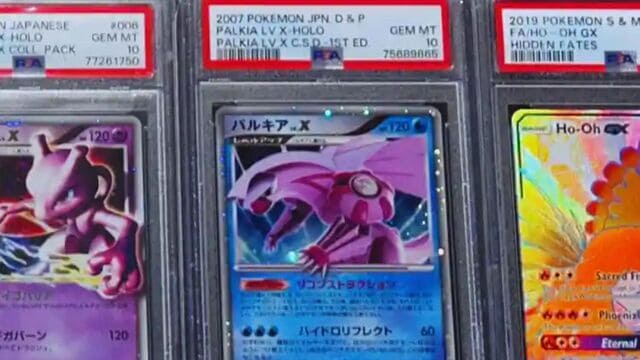 Pokemon cards displayed in a store, showcasing various PSA graded cards for collectors and enthusiasts.
