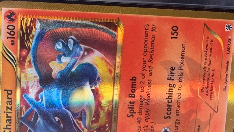 A Pokémon card featuring a vibrant red and blue background, showcasing the Pokémon printline.
