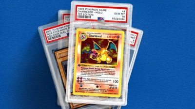 Several graded trading cards in clear PSA plastic slabs are stacked and fanned out against a blue background. The front card is a 1999 Pokémon Game Charizard holographic 1st Edition card graded PSA 4, featuring classic Charizard artwork with a yellow border and holographic foil background. Other graded cards are partially visible behind it, including additional Pokémon and Yu-Gi-Oh! cards with red-and-white PSA labels at the top.